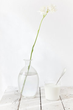 tuberose flower and glass of milk with spoon