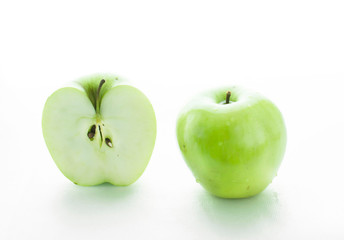 Two big green apples and half of apple on white background