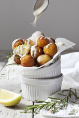 balls of fried potatoes with dripping yogurt sauce from spoon