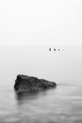 Fototapeta na wymiar Minimalist landscape image of shipwreck ruin in sea black and wh