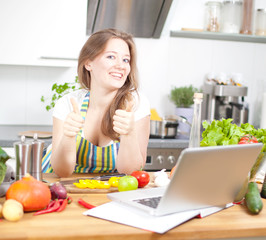 Frau mit Laptop in der Küche 