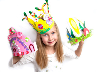 Little girl demonstrating her craft works and Easter bonnet