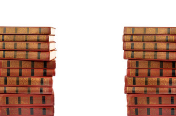 A stack of old books with gold stamping on a white background is