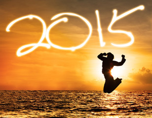 Silhouette of girl with number 2015 in sunset