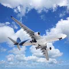 Jet in a blue cloudy sky