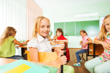 Positive pupils turned back of the class sitting