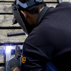 welder worker welding metal