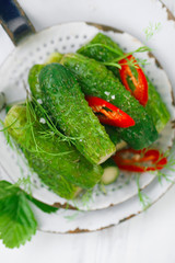 freshly-salted cucumbers on vintage enamel sieve