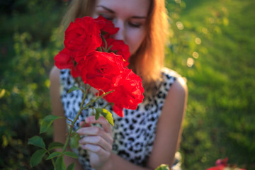 Red rose with girl's face on golden back lighting sunset summer