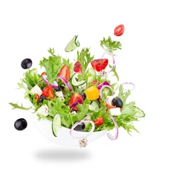 Fotobehang Fresh salad with flying vegetables ingredients © Lukas Gojda