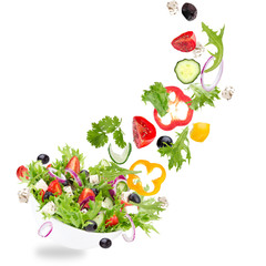 Fresh salad with flying vegetables ingredients