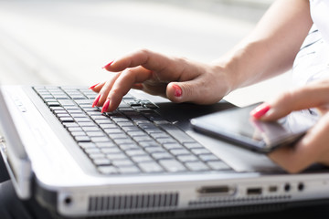 Fototapeta na wymiar Hands of a businesswoman typing on a computer keyboard