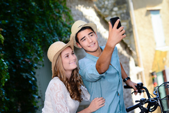 happy young couple making selfie during romantic journey europe