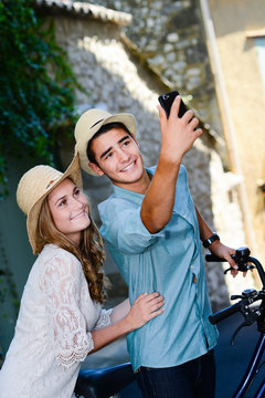 happy young couple making selfie during romantic journey europe