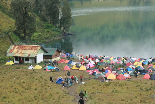 Ranu Kumbolo Lake. Tent in the side of lake.  Group of hiker camping on the side of lake