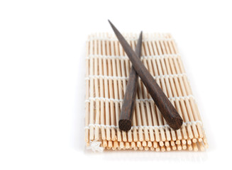 Chopsticks over bamboo mat