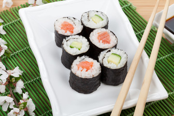 Sushi maki set with fresh sakura branch