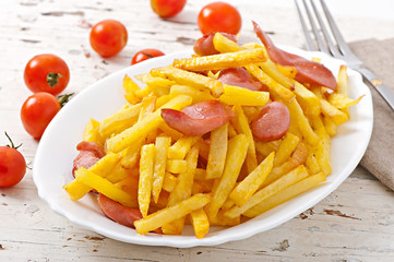 Fried potatoes with sausage on a plate