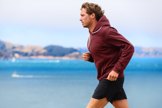 Runner athlete man running in sweatshirt