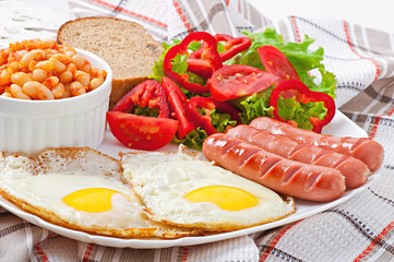 English breakfast - sausages, eggs, beans and salad