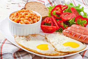English breakfast - sausages, eggs, beans and salad