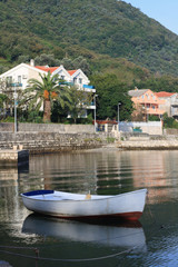 Fototapeta premium White fishing boat near the village Stoliv in Montenegro.
