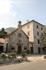 Fototapeta na wymiar The Catholic Church and the house in a village in Montenegro