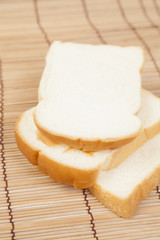 Sliced ​​bread on the wooden plate.