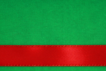 red ribbon on green fabric background with copy space. - Powered by Adobe