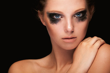 Fototapeta premium Fashion girl crying make up on black