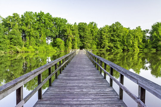 Pond in Alabama and wooden foot bridge