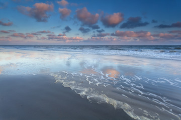 sunrise sky reflected in North sea waves