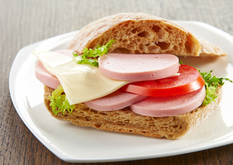 sandwich with sausage and tomato