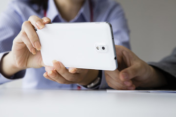 Two women look together mobile phone