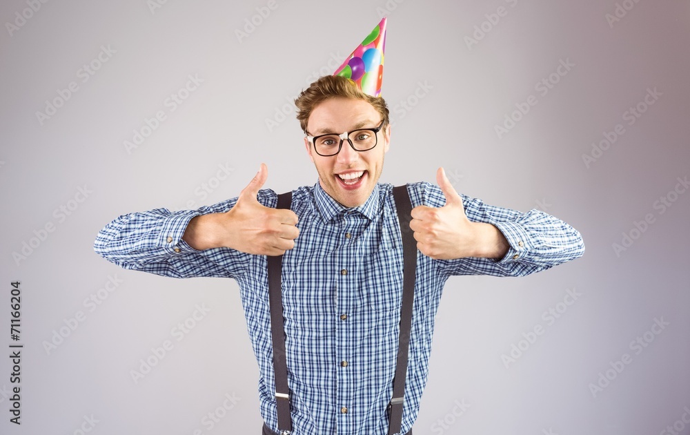 Poster geeky hipster wearing party hat smiling at camera