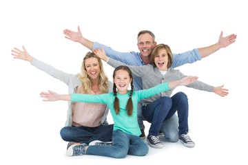 Obraz premium Cheering family with two children sitting on the floor