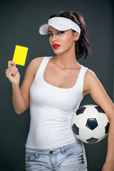 Attractive football referee with yellow card