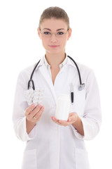 Fototapeta premium young attractive female doctor holding pills isolated on white