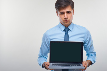 Business man holding a laptop against a white background