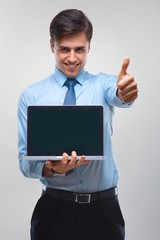 Business man holding a laptop against a white background