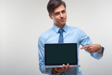 Business man holding a laptop against a white background