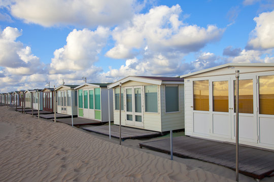 Several beachhouses in a row on beach in The Netherlands