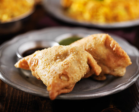 indian samosa with mint and hot chutney close up