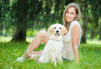Woman playing with her her golden retriever outdoors