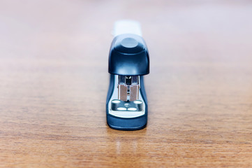 stapler on  wooden background