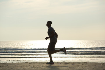 Fototapeta premium Healthy young man jogging on beach