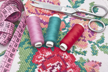 Fototapeta na wymiar Cross-stitch set: colorful threads and canvas