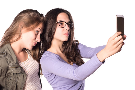 Two young girls making self-portrait with smart phone