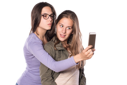 Two young girls making self-portrait with smart phone
