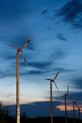 old wind turbine on sunset